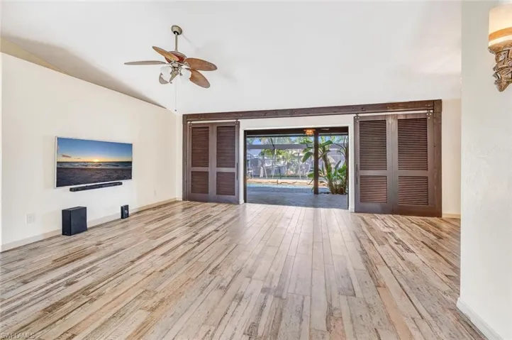 Unfurnished living room with light hardwood / wood-style floors and ceiling fan