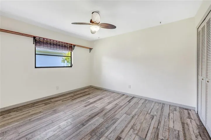 Unfurnished bedroom with a closet, ceiling fan, and light hardwood / wood-style flooring