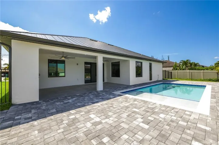 View of pool featuring a patio area and ceiling fan
