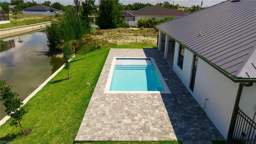 View of swimming pool with a yard and a patio area