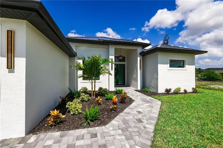View of exterior entry with landscaping