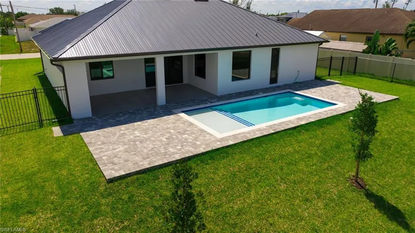 View of pool featuring a patio area and a yard