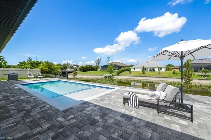 View of pool with a yard and a patio