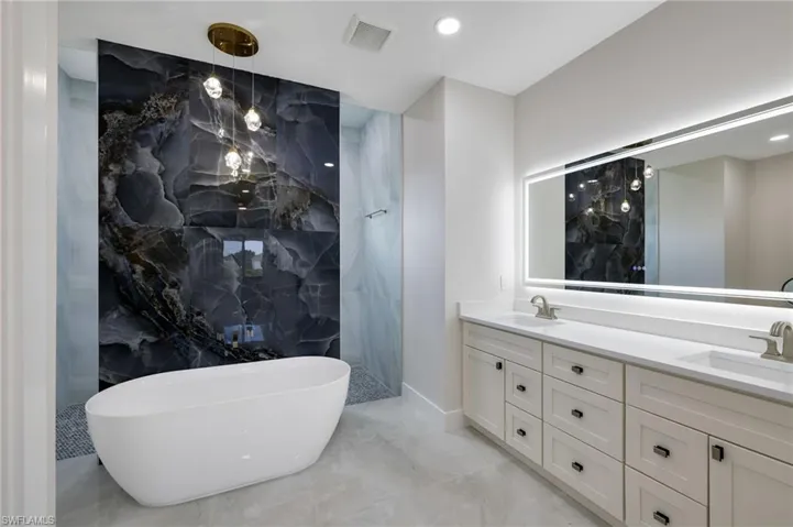 Bathroom with tile flooring and dual vanity