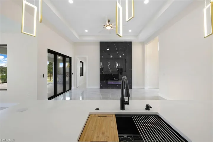 Kitchen featuring ceiling fan and a raised ceiling