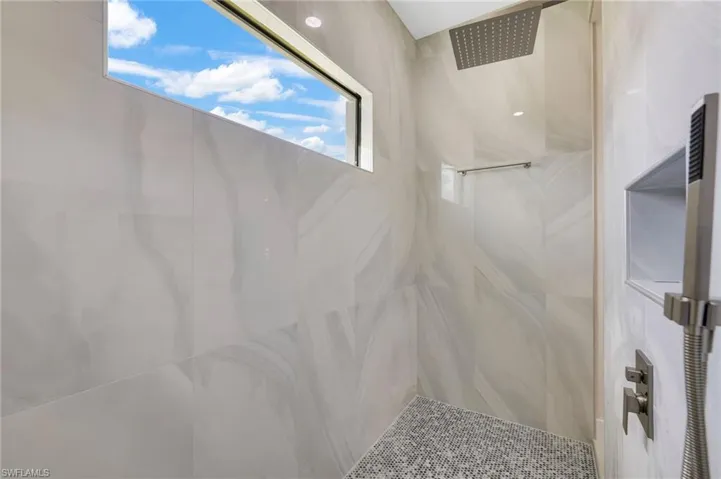 Bathroom featuring a tile shower