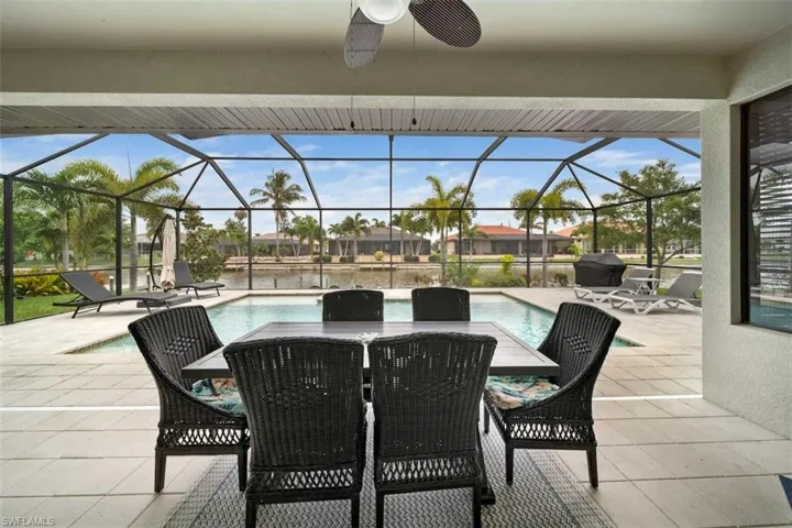 View of patio featuring a lanai and ceiling fan