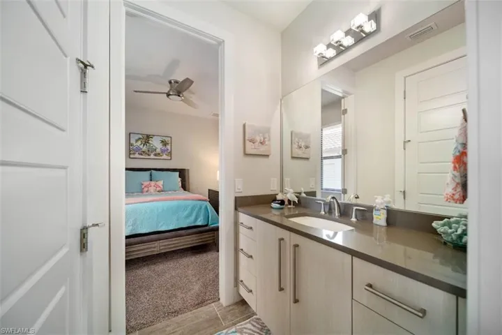 Bathroom with vanity and ceiling fan