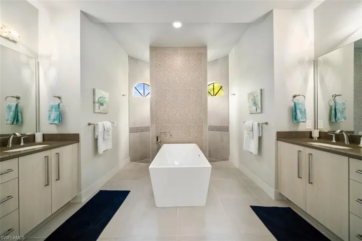 Bathroom with vanity, tile patterned floors, and walk in shower