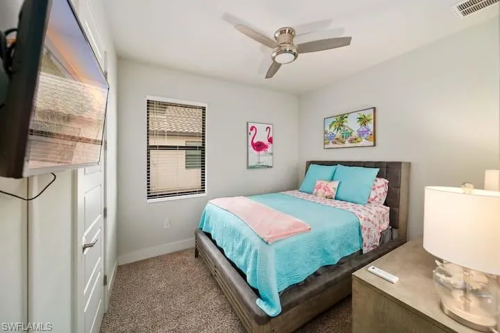 Carpeted bedroom with ceiling fan