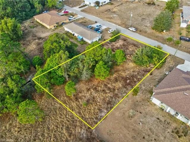 Aerial view of property and surrounding area featuring property parcel outlined