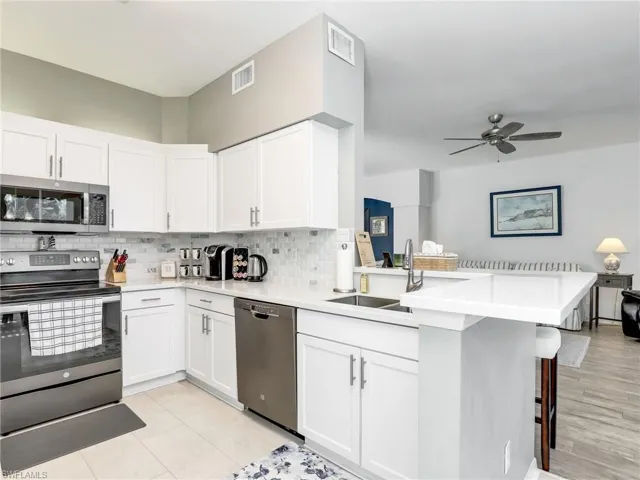 Kitchen with Stainless Steel Appliances & Breakfast Bar