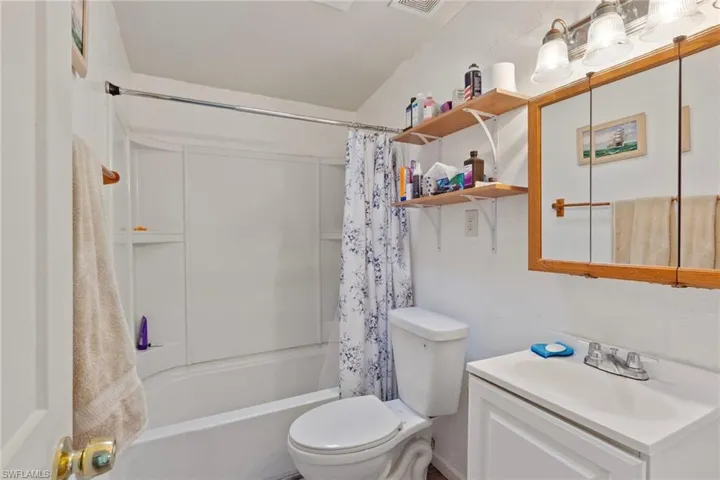 Full bathroom featuring vanity, toilet, and shower / tub combo