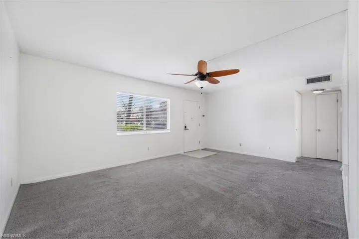 Spare room with carpet floors and ceiling fan