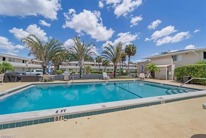 Community pool featuring a patio area, a residential view, and area for grilling