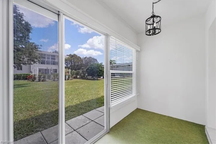 Unfurnished sunroom with a chandelier