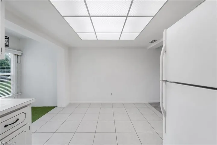 Unfurnished dining area featuring light tile patterned flooring