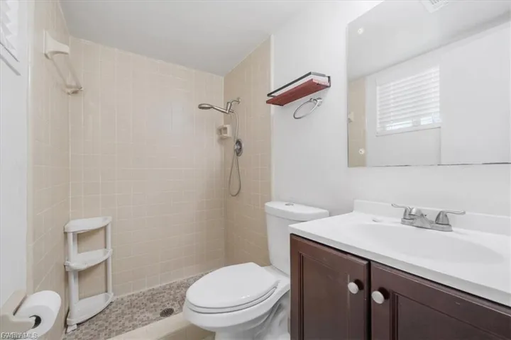 Full bath featuring vanity and a tile shower