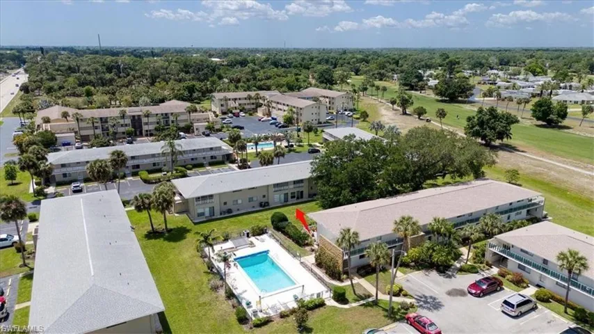 Aerial view of apartment complex / building and a pool area