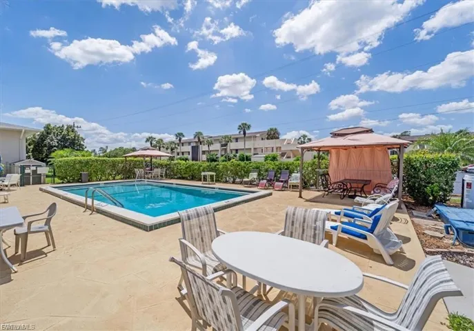 Community pool with a gazebo and a patio area