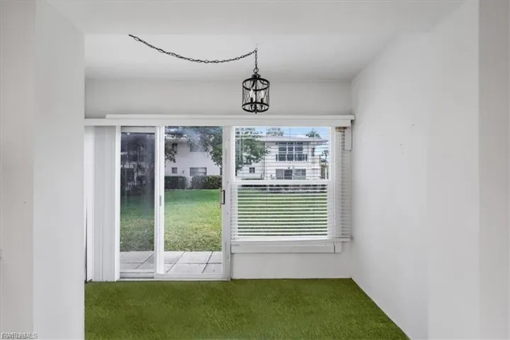 Entryway featuring carpet floors and a chandelier