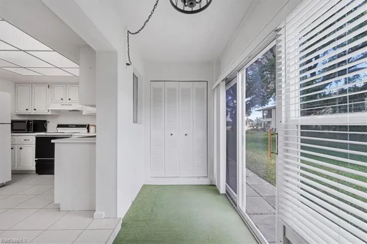 Doorway with carpet flooring and tile patterned floors