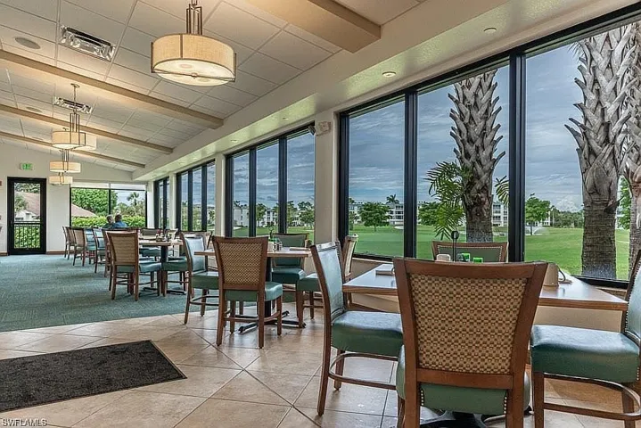Sunroom with view of golf course and vaulted ceiling