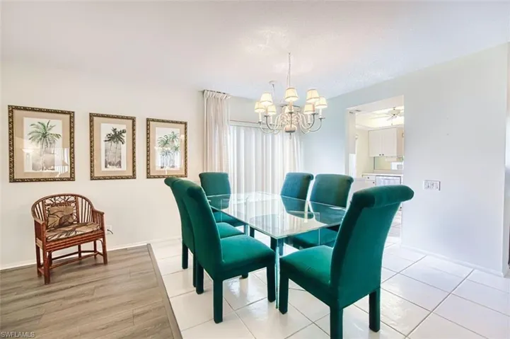 Dining space with suspended lighting, light tile patterned floors, and a ceiling fan