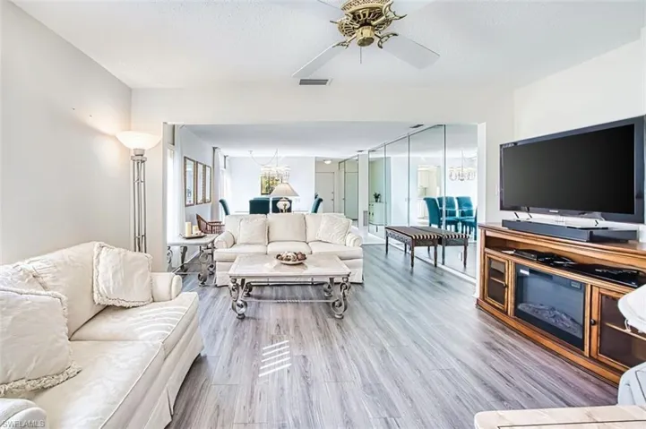 Living area with wood finished floors and ceiling fan