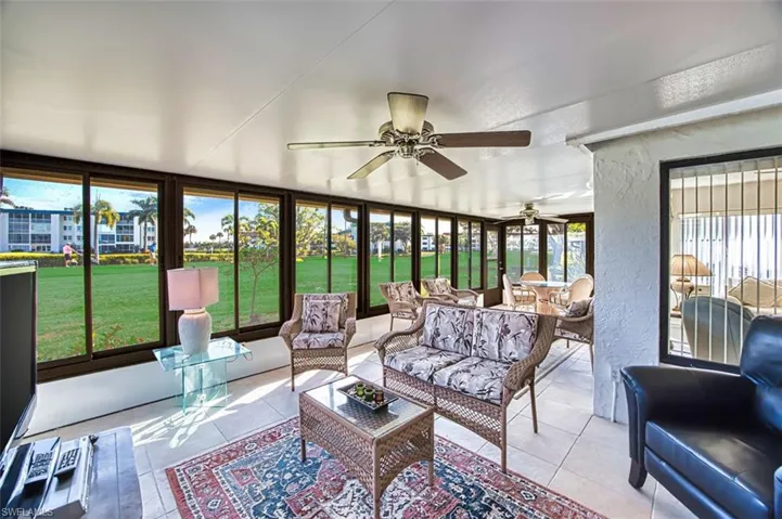 Sunroom featuring a textured wall and tile patterned flooring