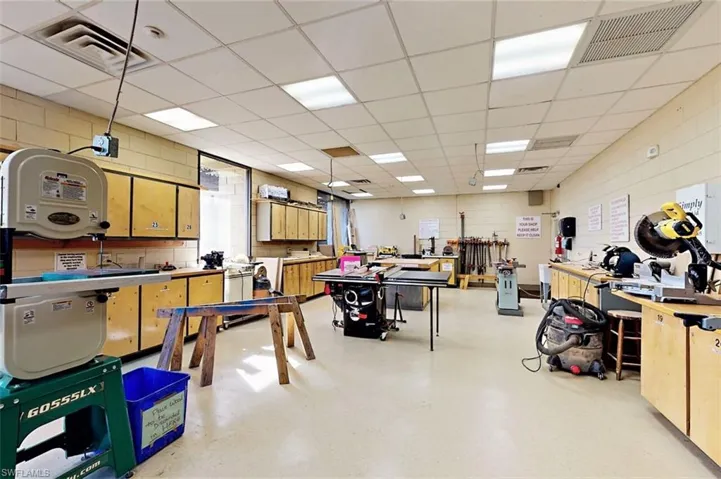 Miscellaneous room with a workshop area and a paneled ceiling