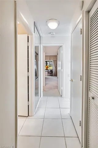 Hallway featuring light tile patterned floors