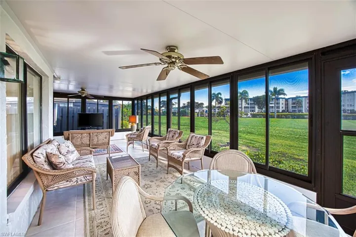 Sunroom / solarium with ceiling fan and outdoor lounge area