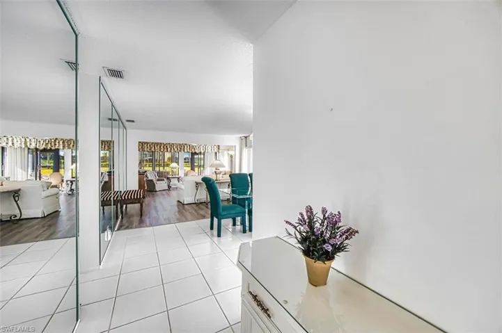 Hallway with tile patterned flooring and a textured ceiling