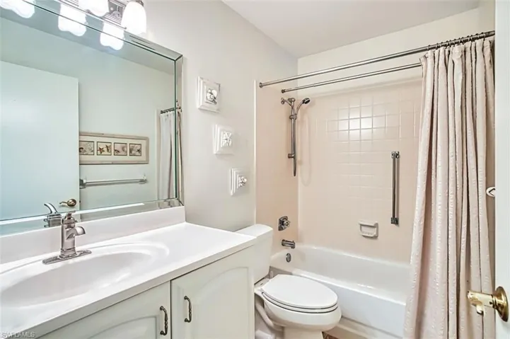 Bathroom with vanity and shower / tub combo