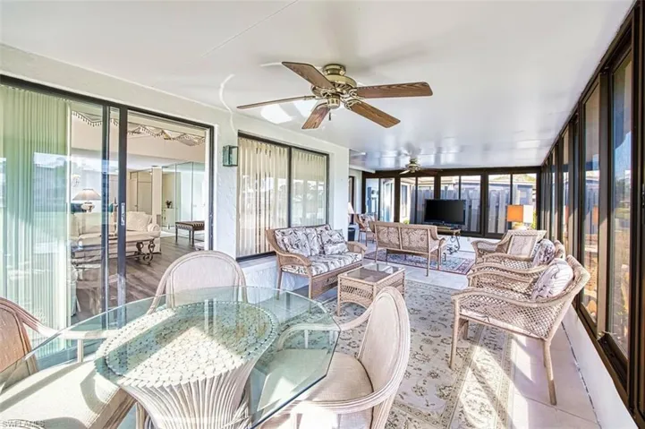 Sunroom / solarium with a ceiling fan and outdoor lounge area