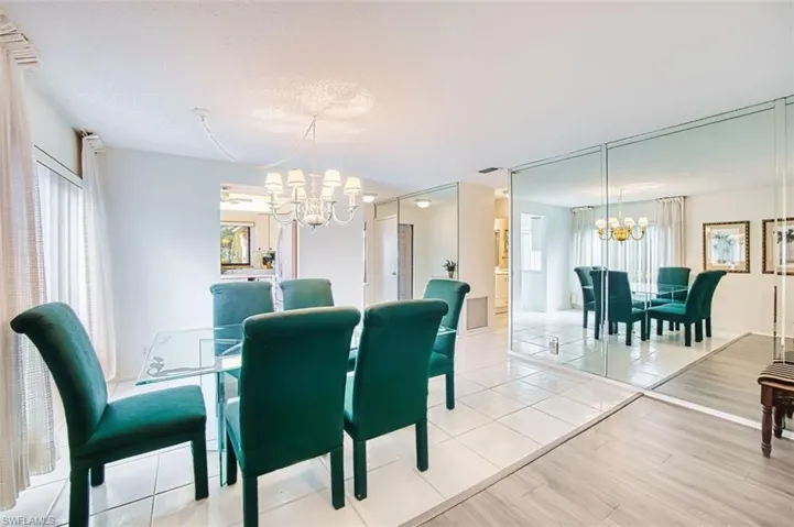 Dining room with suspended lighting and light wood-type flooring