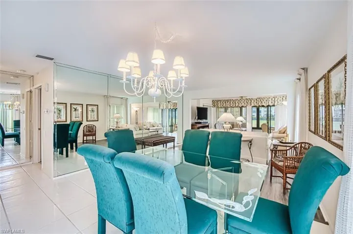 Dining area featuring suspended lighting, plenty of natural light, and tile patterned flooring