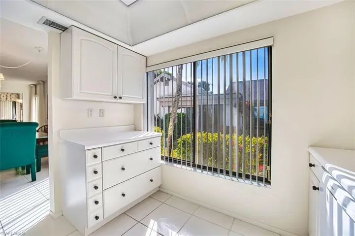 Kitchen with white cabinetry, light countertops, and light tile patterned floors