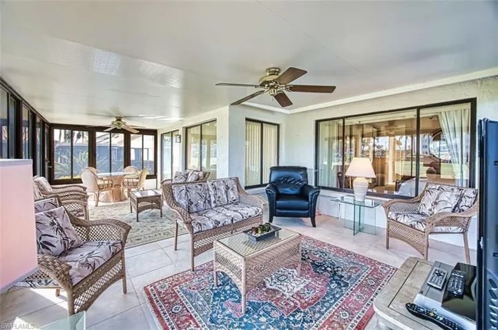 Sunroom featuring tile patterned flooring and ornamental molding