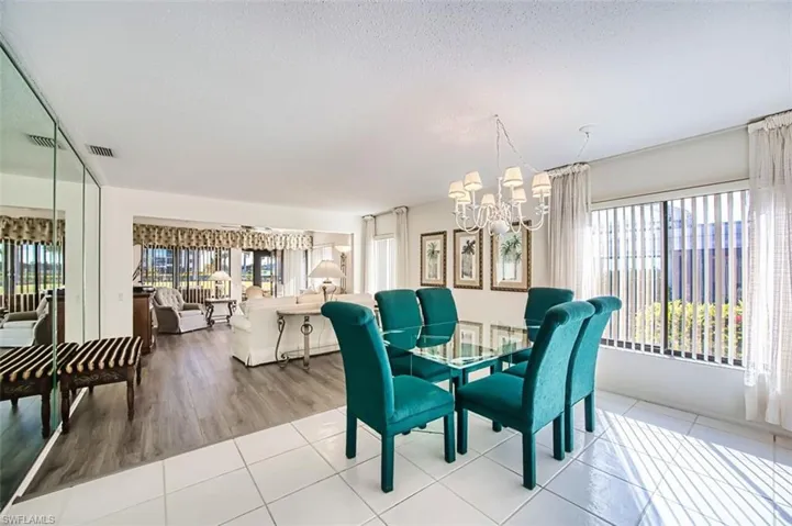 Dining area with suspended lighting and tile patterned floors