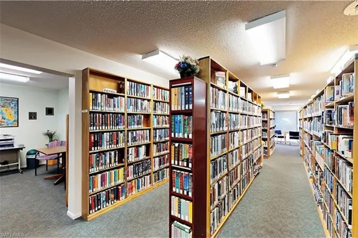 Misc room with bookshelves and a textured ceiling