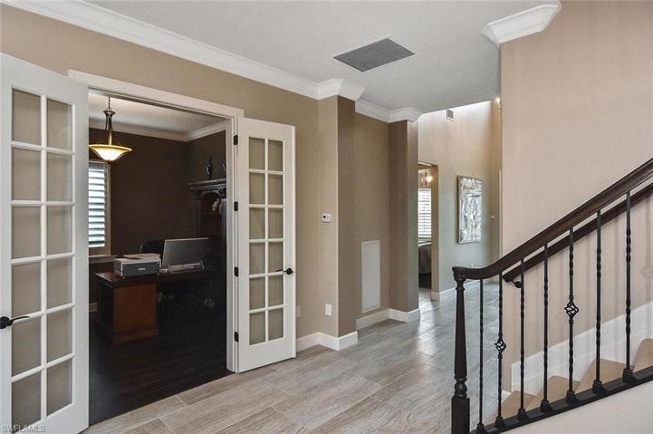 Double French glass doors lead to the Office/Den