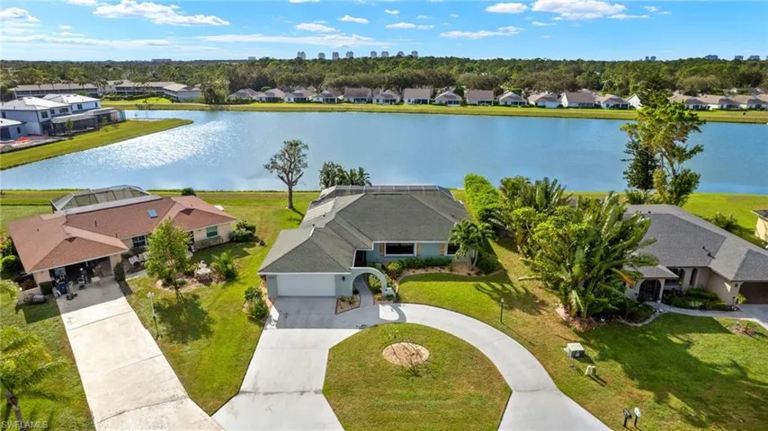 Birds eye view of property with a water view
