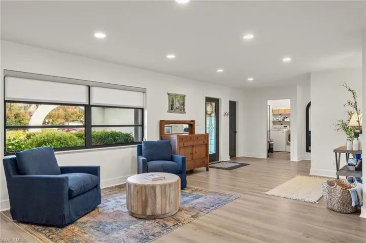 Sitting room with washer / dryer and light hardwood / wood-style flooring