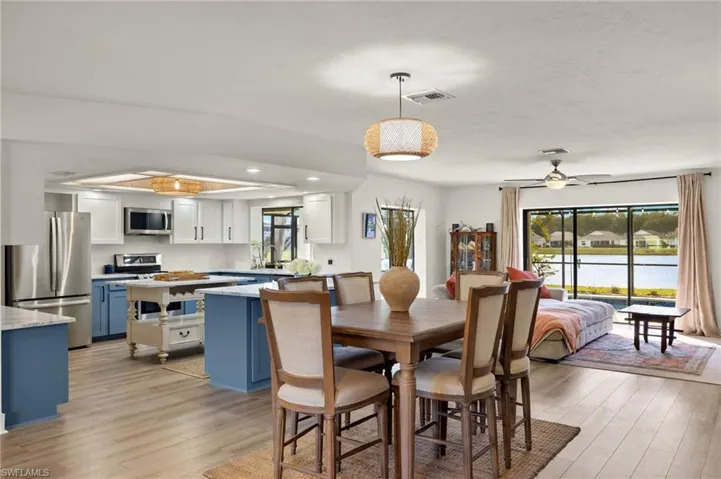 Dining area with light wood-type flooring and ceiling fan
