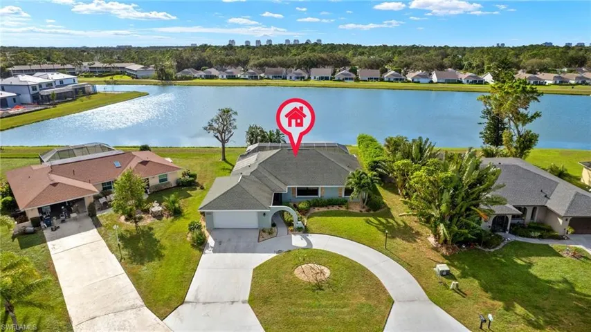 Birds eye view of property with a water view