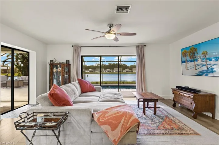 Living room featuring light hardwood / wood-style floors, a healthy amount of sunlight, and ceiling fan