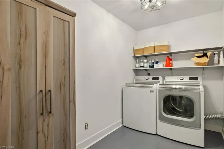 Clothes washing area featuring washing machine and clothes dryer