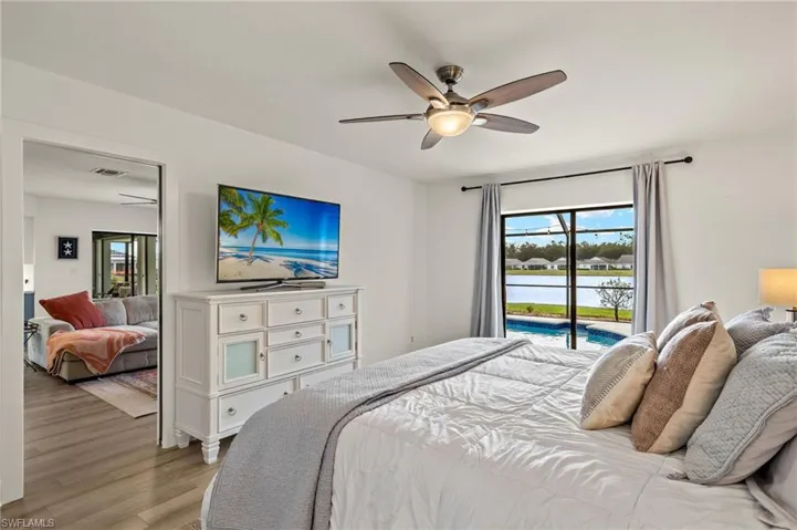 Bedroom with ceiling fan, access to outside, and light wood-type flooring